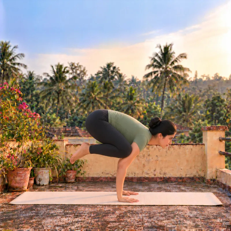 Woman demonstrating Bakāsana, crow pose