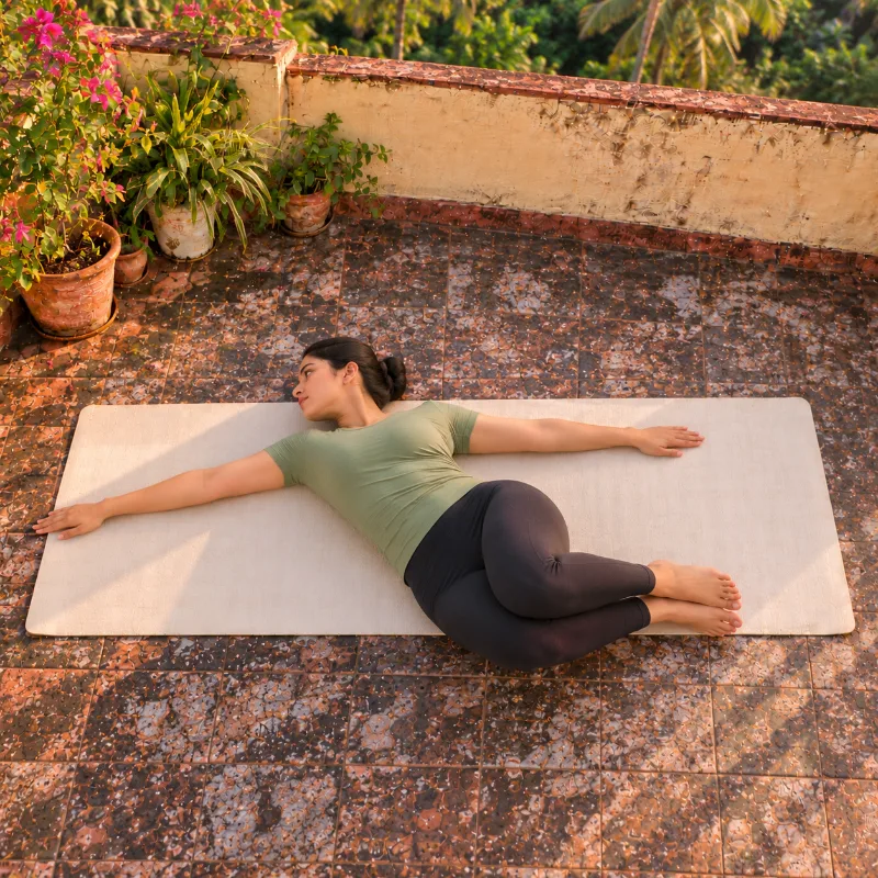 Woman demonstrating Markaṭāsana, monkey pose