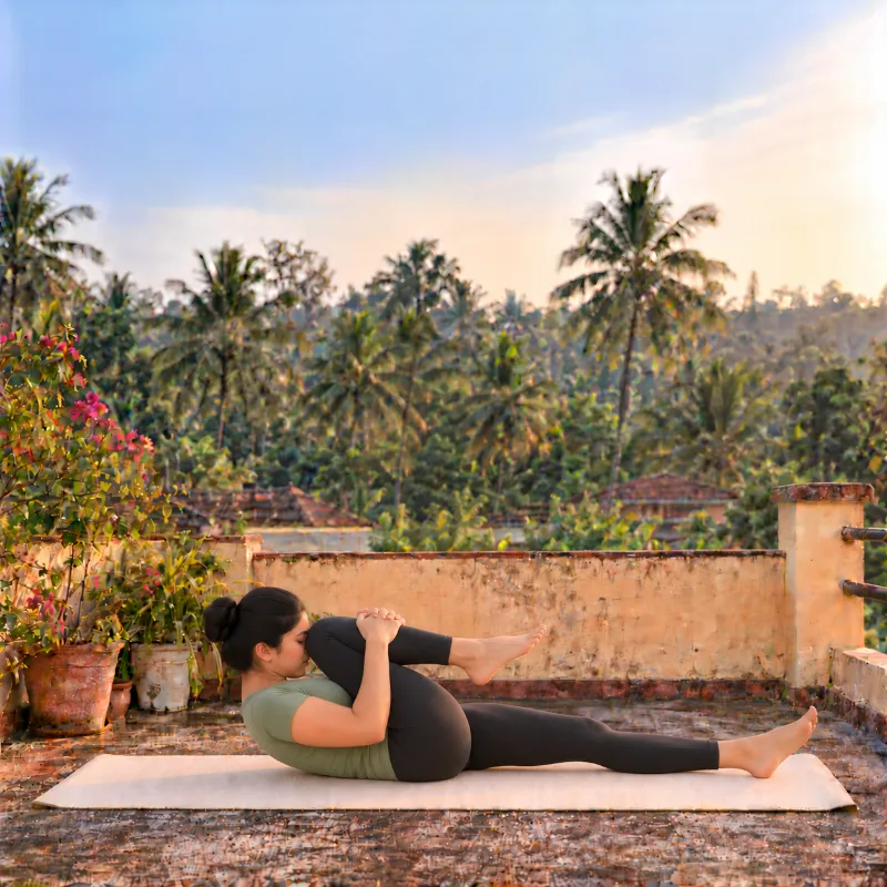 Woman demonstrating Pavanamuktāsana, wind-relieving pose