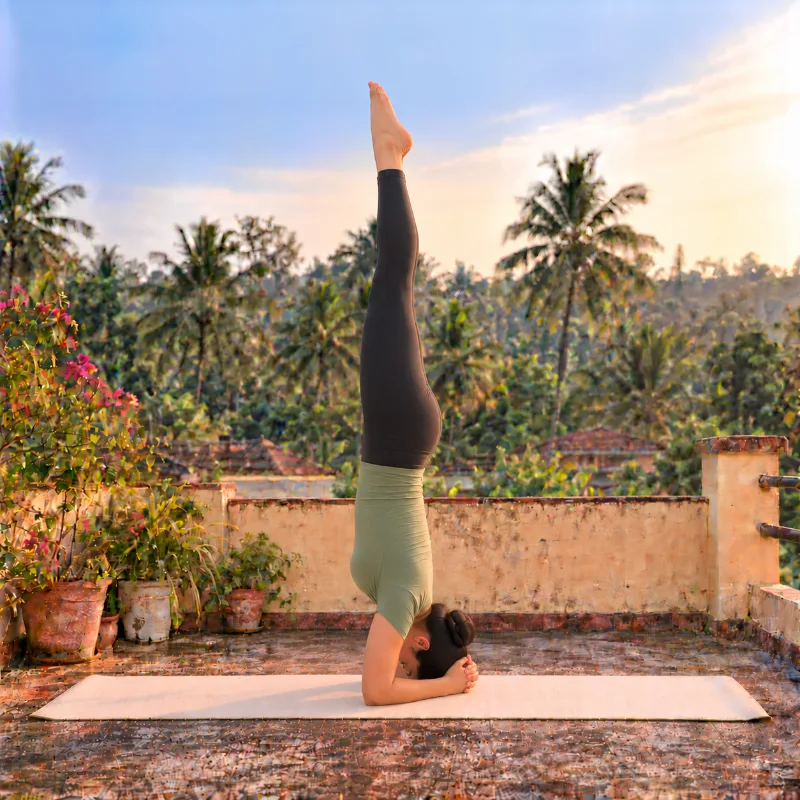 Woman demonstrating Śīrṣāsana, headstand