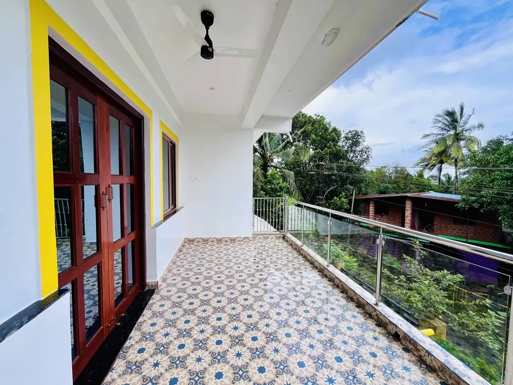 Shared balcony with patterned tiles looking out over trees
